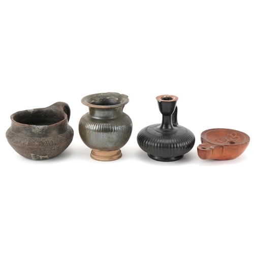 351 - Group of four Roman terracotta items, circa 400 BC, comprising an oil burner, two drinking vessels a... 