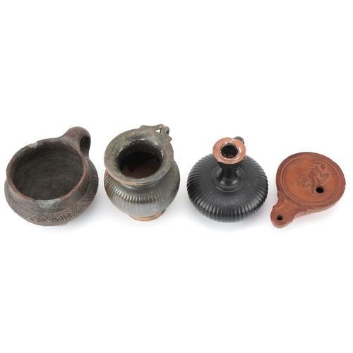 351 - Group of four Roman terracotta items, circa 400 BC, comprising an oil burner, two drinking vessels a... 