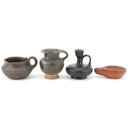 351 - Group of four Roman terracotta items, circa 400 BC, comprising an oil burner, two drinking vessels a... 