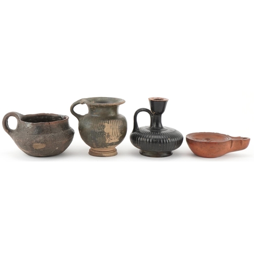 351 - Group of four Roman terracotta items, circa 400 BC, comprising an oil burner, two drinking vessels a... 