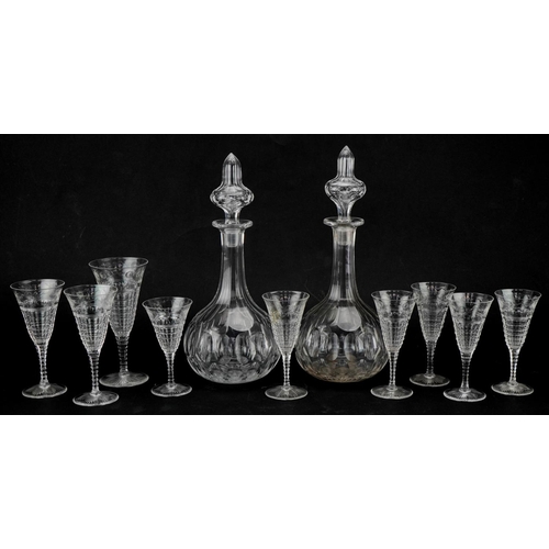 614 - Pair of cut glass decanters together with a small collection of wine glasses