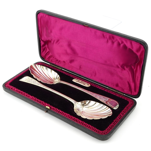 460 - Charles Lias, pair of Victorian silver gilt serving spoons with shell shaped bowls housed in a velve... 