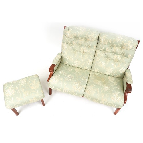 674A - Mahogany framed two seater settee and footstool with green floral upholstery, 118cm wide