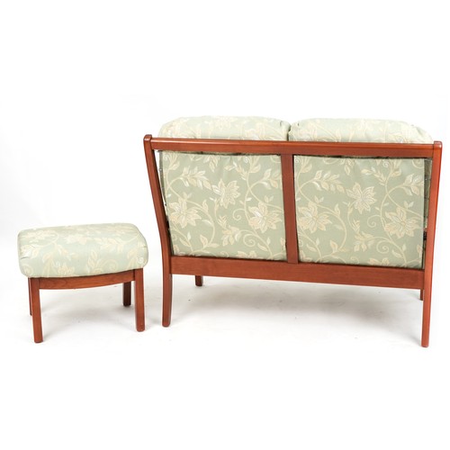 674A - Mahogany framed two seater settee and footstool with green floral upholstery, 118cm wide