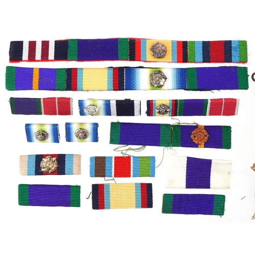 2553 - Collection of decorative military interest cap badges and medal bars