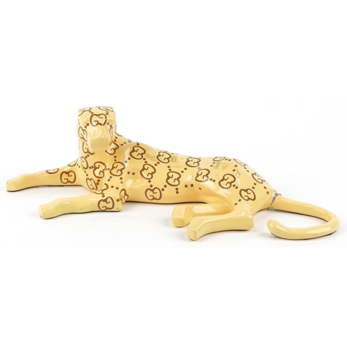 1182 - Gucci style model of a recumbent leopard, 60cm in length