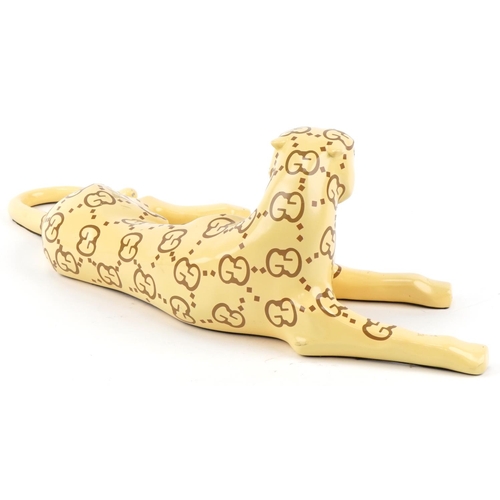 1182 - Gucci style model of a recumbent leopard, 60cm in length