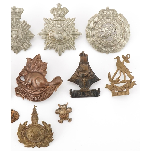 2562 - Twelve military interest cap badges including British American, Duke of Edinburg's Own Volunteer Rif... 