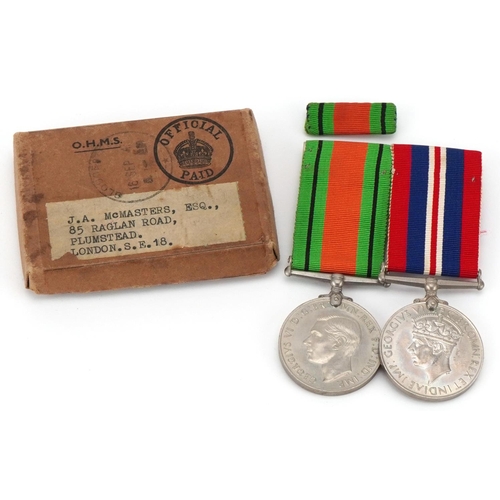 2523 - British military World War II medal pair with bar and box of issue to J A McMasters, Esq