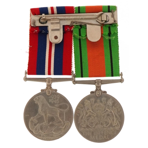 2523 - British military World War II medal pair with bar and box of issue to J A McMasters, Esq