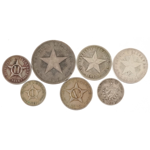 2129 - Seven early 20th century Cuban coins, five silver, the earliest date 1915, the largest denomination ... 