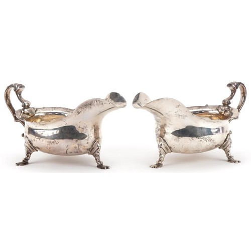 407 - C S Harris & Sons Ltd, pair of George V silver three footed sauce boats, London 1911, each 17.5cm in... 