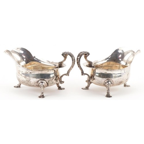 407 - C S Harris & Sons Ltd, pair of George V silver three footed sauce boats, London 1911, each 17.5cm in... 