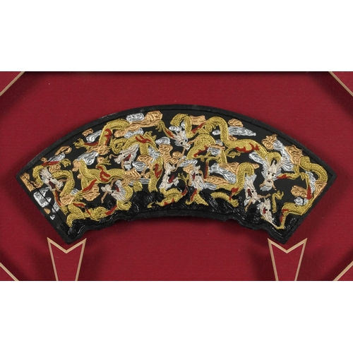 393 - Late 20th century Chinese framed ink block depicting multiple dragons, within red pierced mount, fra... 