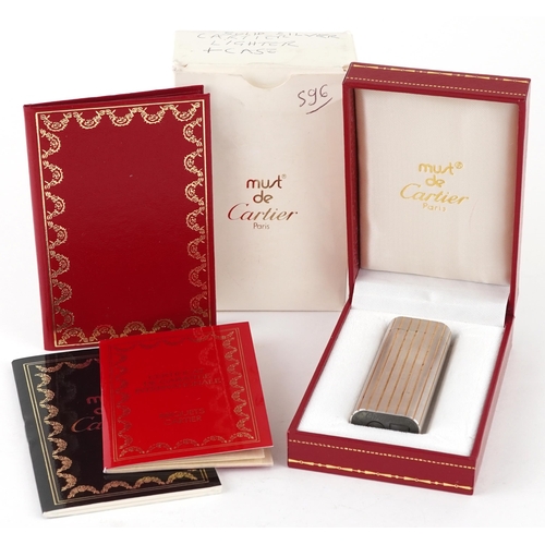 171 - Must de Cartier, engine turned pocket lighter with box and certificate, numbered 40862 , 7cm high