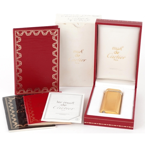 170 - Must de Cartier, gold plated engine turned pocket lighter with box and certificate, 7cm high