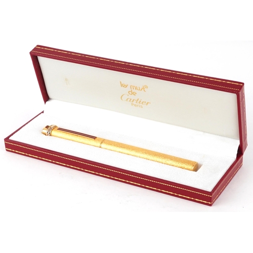 175 - Les Must de Cartier, gold plated bark design ballpoint pen with box and certificate numbered 373911