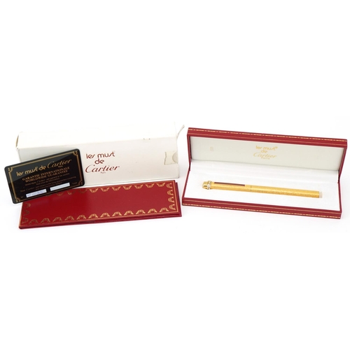 175 - Les Must de Cartier, gold plated bark design ballpoint pen with box and certificate numbered 373911