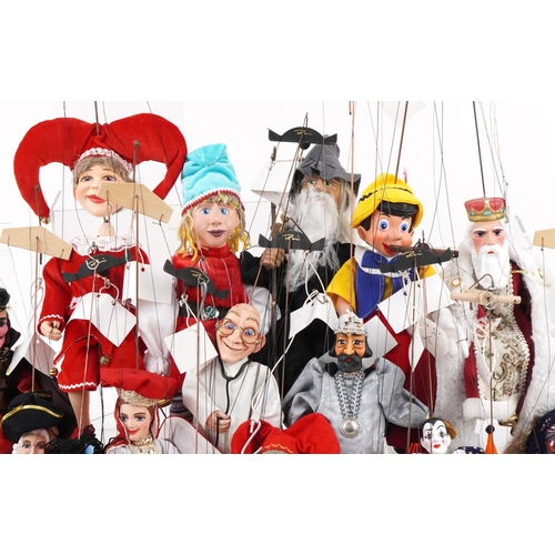 2043 - Collection of 20th century carved wood puppets, all with painted decoration, the largest 40cm high