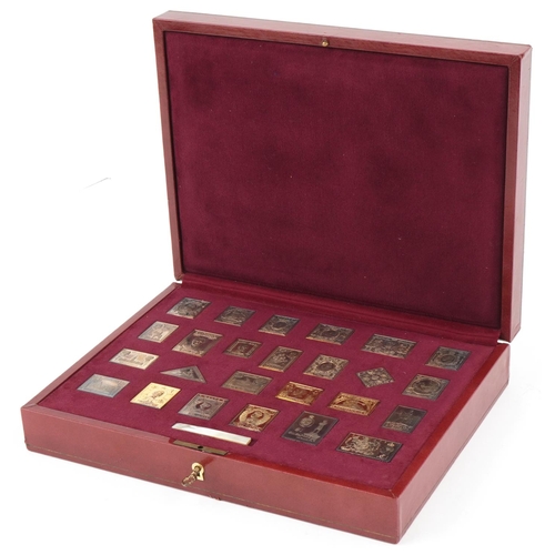 412 - The Empire Collection, twenty five silver replica stamps, gold plated, fitted in a red leather case,... 