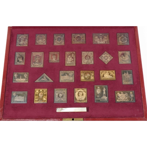 412 - The Empire Collection, twenty five silver replica stamps, gold plated, fitted in a red leather case,... 