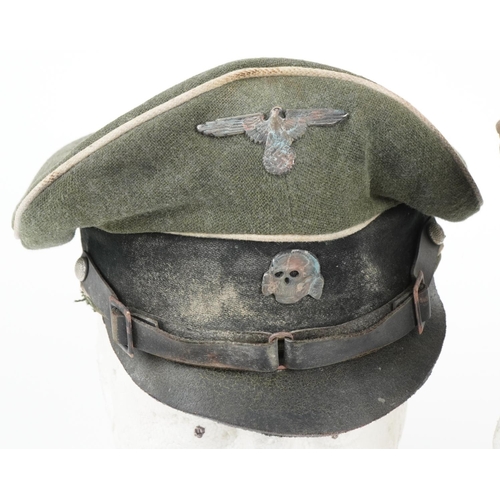 2645 - Two German military interest visor caps with badges