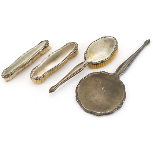 457 - Four German silver backed vanity items including hand mirror and clothes brush, the largest 32cm in ... 