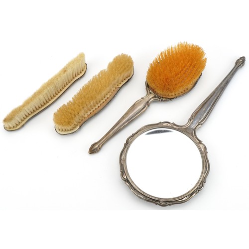 457 - Four German silver backed vanity items including hand mirror and clothes brush, the largest 32cm in ... 