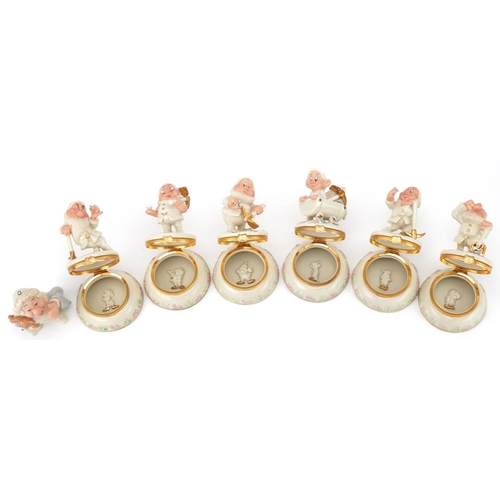 512 - Six Lenox porcelain Disney Dwarf trinkets and one other, the trinkets each housing a charm, 10cm hig... 