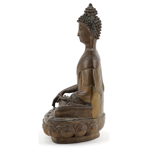 214 - Large Tibetan bronze figure of a Buddha seated on  a lotus throne, 40cm H x 26cm W x 17cm D