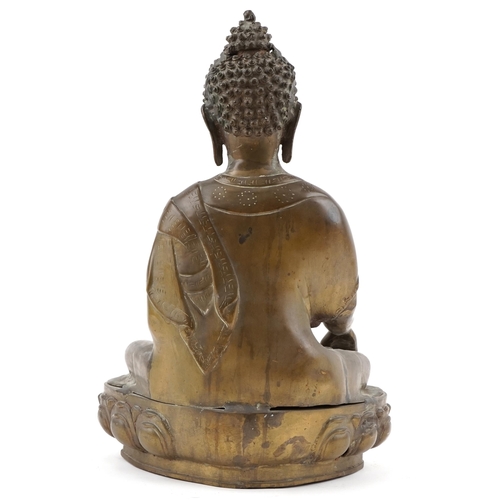 214 - Large Tibetan bronze figure of a Buddha seated on  a lotus throne, 40cm H x 26cm W x 17cm D