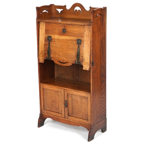 1009 - Late Victorian Arts & Crafts ladies oak bureau with copper strapwork hinges revealing an interior wi... 