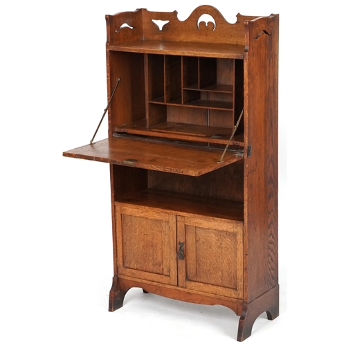 1009 - Late Victorian Arts & Crafts ladies oak bureau with copper strapwork hinges revealing an interior wi... 