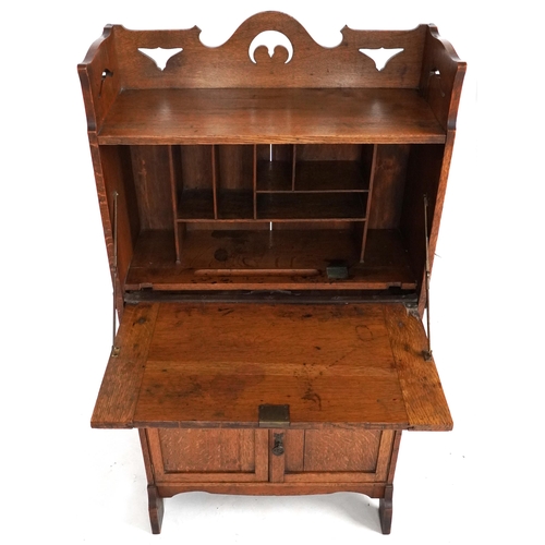 1009 - Late Victorian Arts & Crafts ladies oak bureau with copper strapwork hinges revealing an interior wi... 