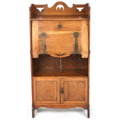 1009 - Late Victorian Arts & Crafts ladies oak bureau with copper strapwork hinges revealing an interior wi... 