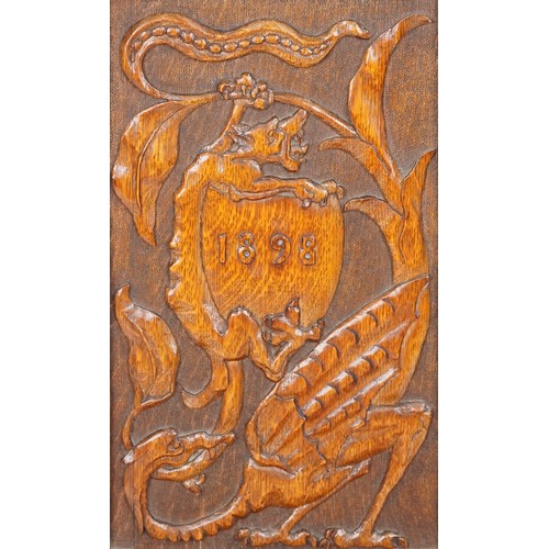 1035 - Victorian oak hall chair heavily carved with a dragon and shield, dated 1898, 120cm high