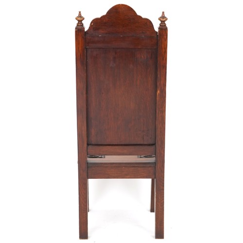 1035 - Victorian oak hall chair heavily carved with a dragon and shield, dated 1898, 120cm high