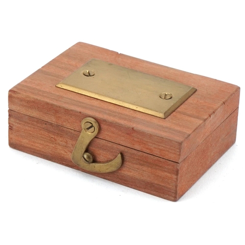 68 - Miniature starting pistol housed in a wooden box, the pistol 4cm in length