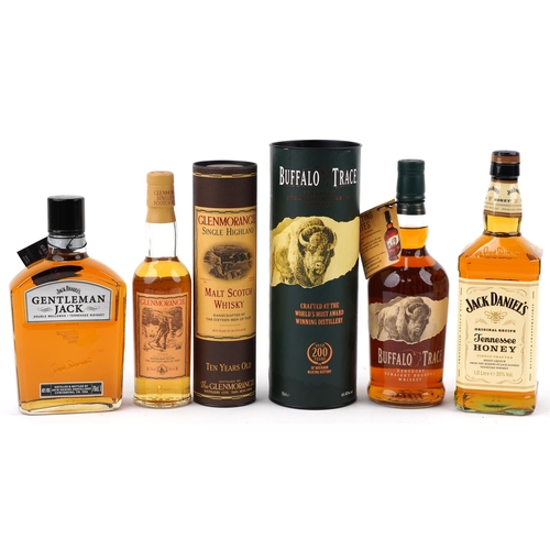 597 - Four bottles of whisky - Jack Daniels Gentleman Jack Tennessee whisky, Jack Daniels Honey Tennessee ... 