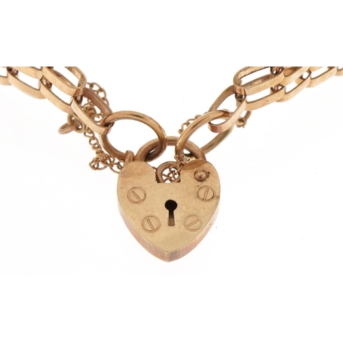 3016 - 9ct gold five row gate bracelet with love heart shaped padlock, 16cm in length, 7.3g