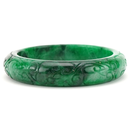 3292 - Chinese carved green jade bangle, 7cm in diameter, 64.0g