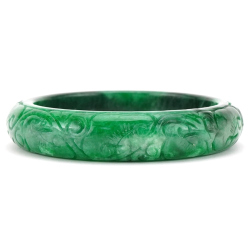 3292 - Chinese carved green jade bangle, 7cm in diameter, 64.0g