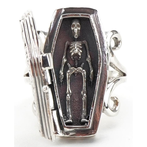 3241 - Silver ring in the form of a coffin opening to reveal a skeleton, size N, 13.5g