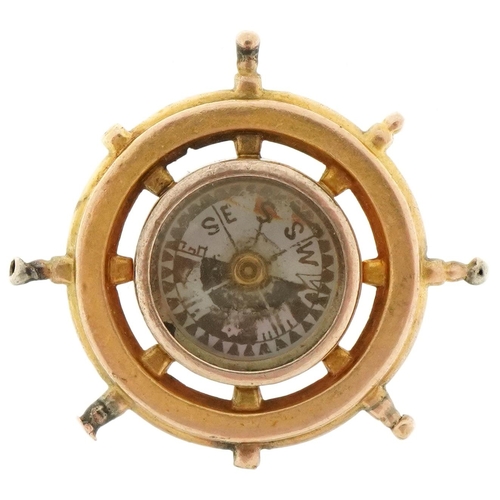 3114 - Antique unmarked gold and carnelian compass fob in the form of a ship's wheel, 2.7cm in diameter, 4.... 