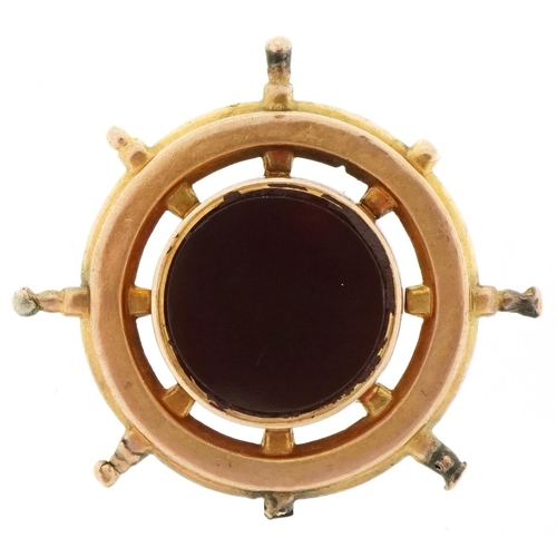 3114 - Antique unmarked gold and carnelian compass fob in the form of a ship's wheel, 2.7cm in diameter, 4.... 