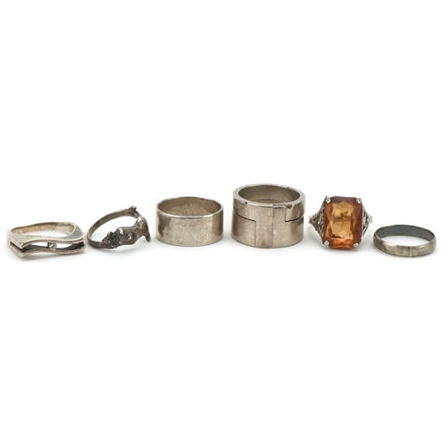 3333 - Six silver and white metal rings including an interlocking two piece ring and one in the form of a c... 