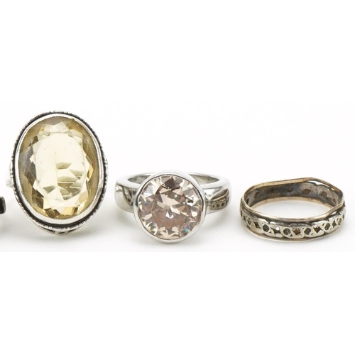 3286 - Six silver rings, some set with semi precious stones, including two eternity rings and a large citri... 