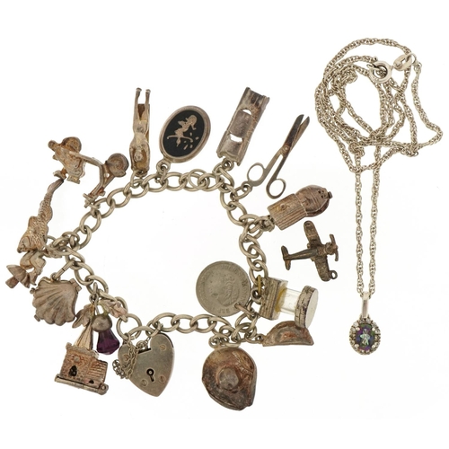 3116 - Silver charm bracelet with a selection of mostly silver charms and a colourful stone pendant on a si... 