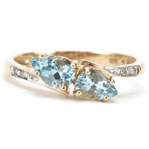 3203 - 9ct gold teardrop aquamarine and diamond crossover ring, size N, 1.7g