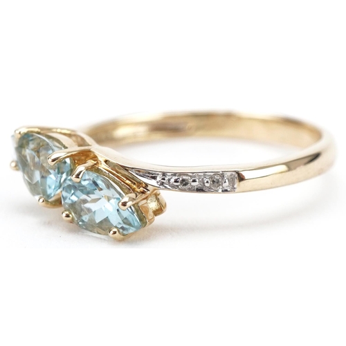 3203 - 9ct gold teardrop aquamarine and diamond crossover ring, size N, 1.7g